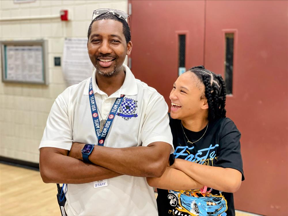 An administrator strikes a pose with a student at Willis